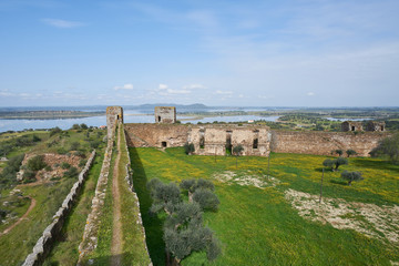 Fototapeta premium Mourao castle towers and wall historic building with alqueva dam reservoir in Alentejo, Portugal