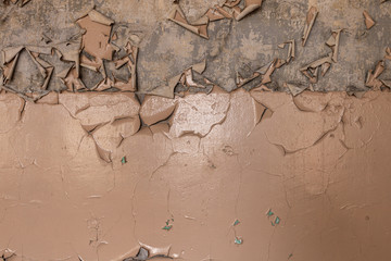 Old oil paint peeling and cracking on concrete wall