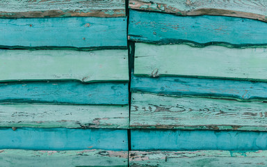Multi-colored wooden fence downed from boards