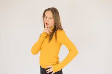 Beautiful young girl with glasses and yellow shirt Beautiful young girl with yellow shirt thoughtful