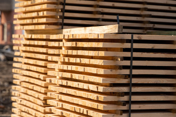 Warehouse for sawing boards on a sawmill outdoors. Timber mill, sawmill. Storage of planed wooden...