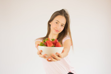 beautiful fitness girl with strawberries