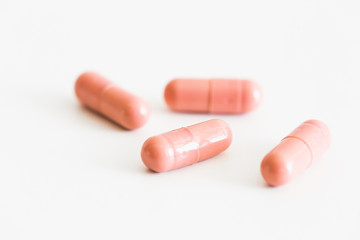 Pills on a light background with place for text. Biological supplements, vitamins, medicines for health.