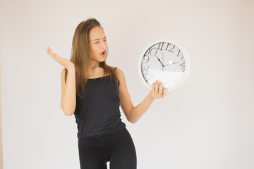 Young beautiful girl with big clock