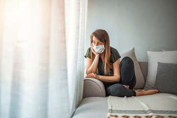 Woman in isolation at home for virus outbreak. Young woman in isolation at home for coronavirus. Woman in Isolation Quarantine Coronavirus. Sad lonely girl isolated stay at home - obrazy, fototapety, plakaty