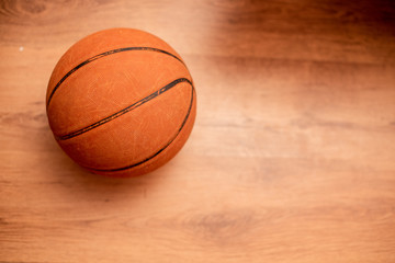 Basketball against hardwood floor shot from above 
