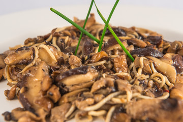 Plate of siitake mushrooms with baby eels