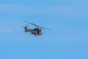 Fototapeta na wymiar Spanish Army Hellicopter patroling during COVID-19 Lockdown, Las Palmas de Gran Canaria, Spain