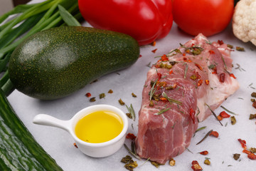 Fresh meat and vegetables for cooking your favorite dishes on a light background