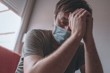 Worried stressed man self-isolated in home quarantine