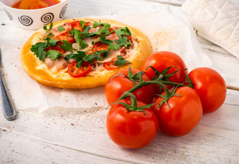 Homemade rustic pizza, with cutlery and with tomatoes