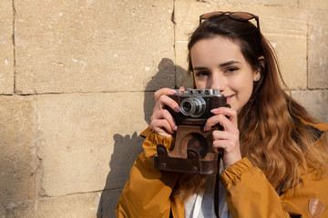 Photo of young tourist girl exploring streets of Baku. Moody photos of teenager girl visiting old city and taking photos of the city