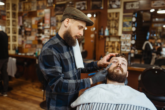 Barber with razor, old school beard cutting