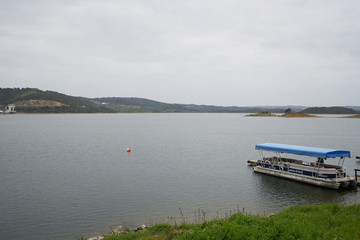 Fototapeta na wymiar Tourism Boat on a marina pier of Alqueva Dam reservoir, in Portugal