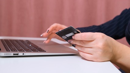 girl making online payment using laptop for shopping at home.