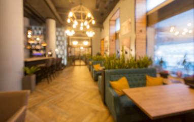 Fototapeta na wymiar Blurred modern restaurant or cafe interior. Public place interior