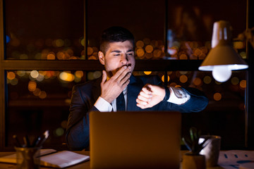 Entrepreneur Man Yawning Working Late Looking At Wristwatch In Office