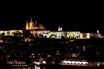 Fototapeta na wymiar View of Prague Castle, St Vitus Cathedral and Mala Strana across the Vltava River, Prague, lit at night.