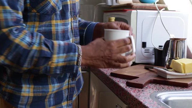 Low view person making bulletproof coffee in the morning