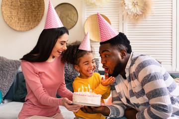 Happy multiracial family celebrate babys birthday during coronavirus