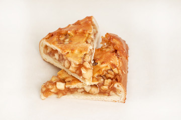 Pie stuffed with apples. Fresh pastries. Closeup on a light background