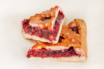 Cake stuffed with sweet red jam. Fresh pastries. Closeup on a light background