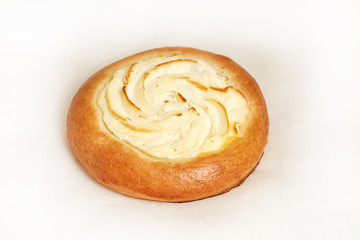 Round cheesecake. Fresh pastries. Closeup on a light background