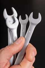 Workshop wrenches held in hand. Accessories for mechanics making repairs in the workshop.