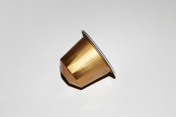 A golden coffee machine capsule