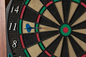 Red and blue dart arrrow hitting in the target.Darts sport concept