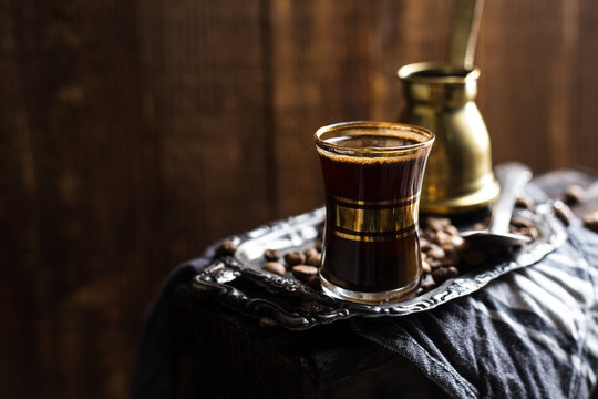 Turkish Coffee Cup With Vintage Copper Stovetop Coffee Pot Shot On A Dark Textured Wooden Background Backlit 