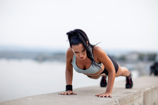 Athletic Woman With Perfect Body Shape Exercise Pushups Outdoor