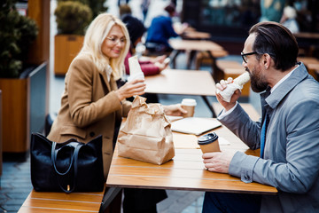 Woman looking at a burrito in her hand