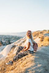 young woman sitting on the rocks