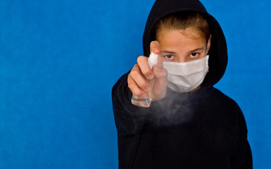 The guy in the mask with a black shirt uses hand shampoo to cleanse the hand and prevent the spread of bacteria and viruses. Concept of personal hygiene.