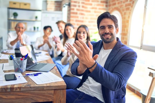 Group of business workers smiling happy and confident. Working together with smile on face looking at the camera applauding at the office