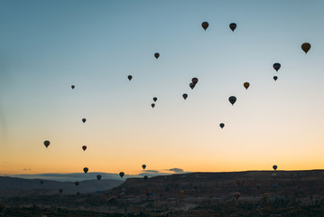 sunrise with hot air baloons in the air