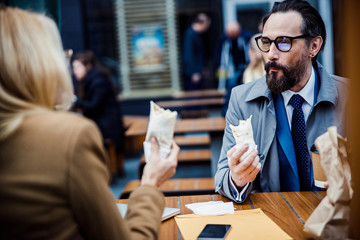 Man sitting at lunch with his female colleague