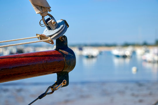 View of bow sprit with roller furling and out of focus boats in the background