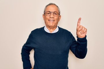 Senior handsome grey-haired man wearing sweater and glasses over isolated white background showing...