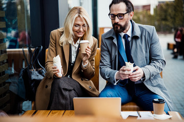 Two coworkers staring at a computer screen