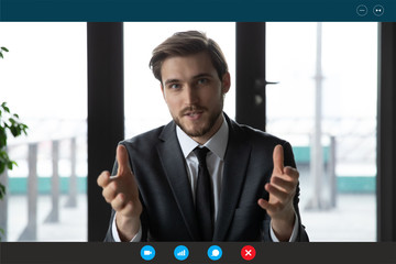 Head shot of confident businessman in suit talk with partner company client or investor use video...