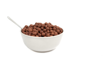 chocolate balls falling into bowl isolated. breakfast