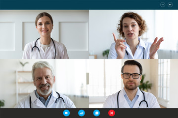 Pc screen webcam view, head shot portrait four diverse medical workers in white coats take part in distant talk, engaged in group video call. Videoconferencing, concilium remote communication concept