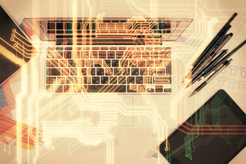 Technology hologram drawing over computer on the desktop background. Top view. Double exposure. Tech concept.