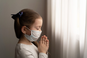 Little girl praying in the morning for a new day freedom to world corona virus.