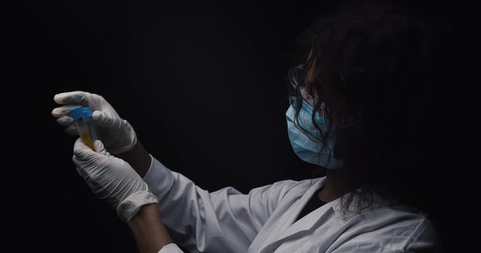 Virologist compares test tube vaccine samples
