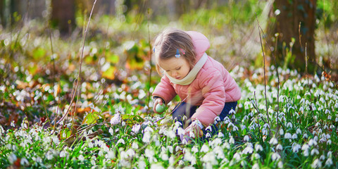 Cute little girl playing egg hunt on Easter