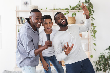 Cheerful Black Father, Son And Grandfather Having Fun At Home, Singing Together