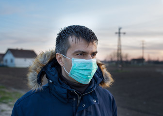 Man with protective mask walking outside